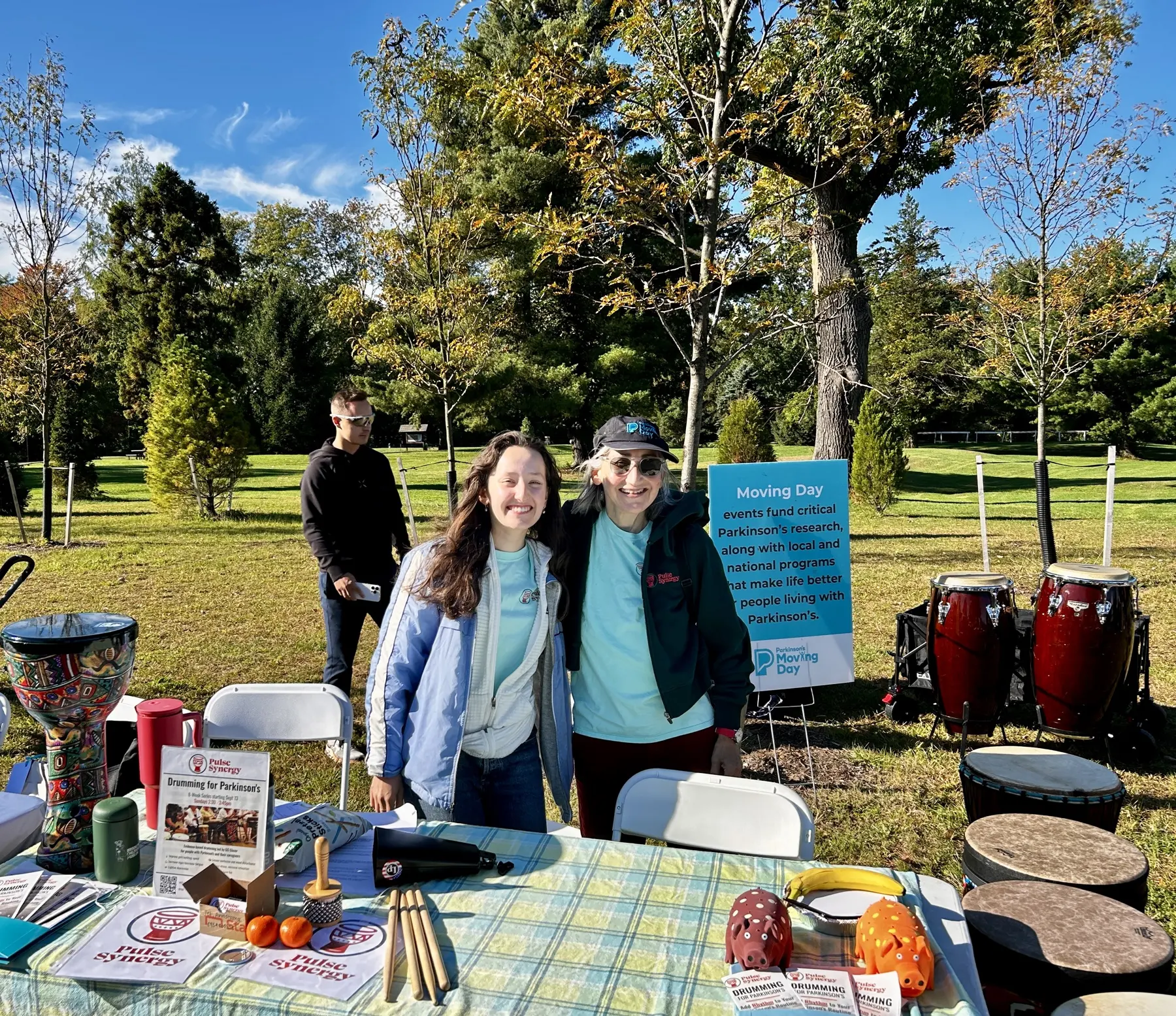 Pulse Synergy team members surrounded by drums and percussion instruments at Moving Day New Jersey